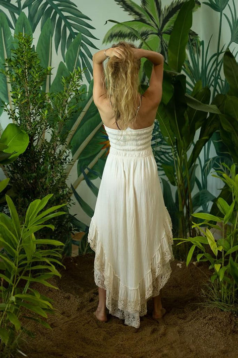 A girl in a  cream romantic Bohemian dress and a necklace