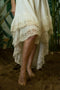 Asymmetric bottom of a natural cotton romantic Boho dress with a cotton lace